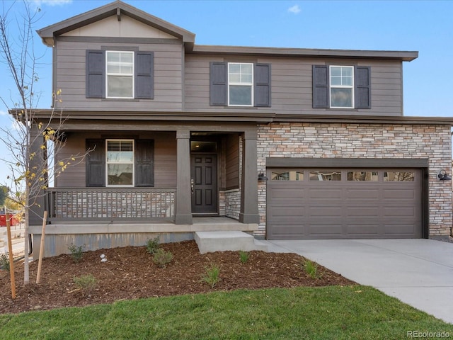 traditional-style house with driveway, covered porch, an attached garage, and stone siding