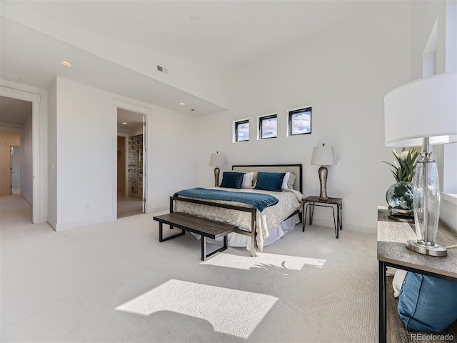 bedroom with a towering ceiling and light carpet