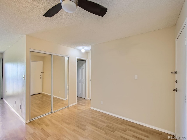 1200 Golden Cir Unit 412, Golden, CO 80401 - unfurnished bedroom with light wood finished floors, a textured ceiling, ceiling fan, and a closet
