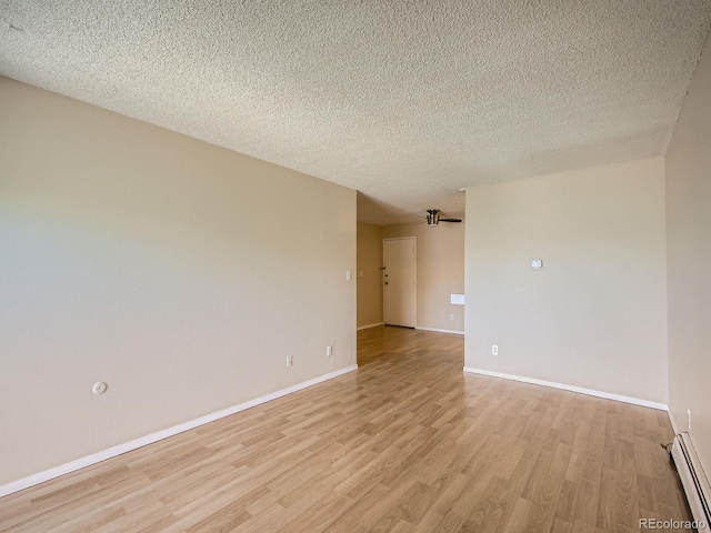 1200 Golden Cir Unit 412, Golden, CO 80401 - unfurnished room with baseboard heating, light wood-type flooring, and a textured ceiling