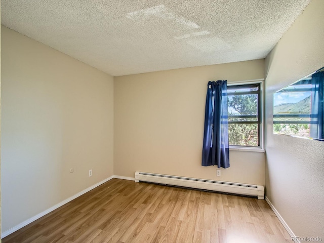 1200 Golden Cir Unit 412, Golden, CO 80401 - unfurnished room featuring a baseboard heating unit, wood finished floors, and a textured ceiling
