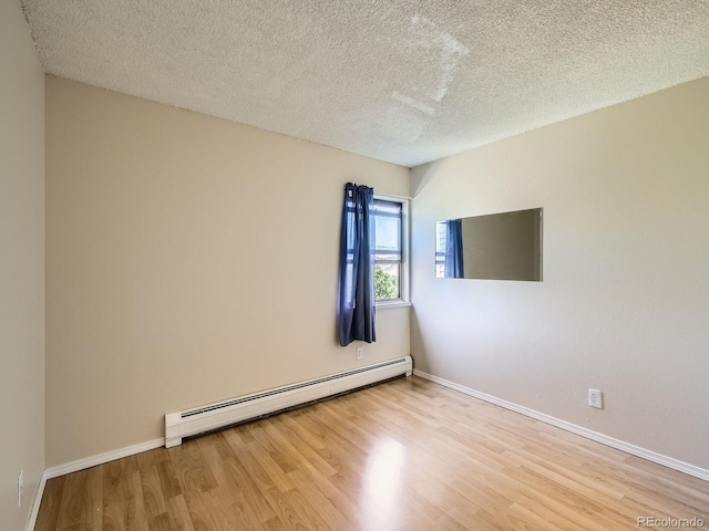 1200 Golden Cir Unit 412, Golden, CO 80401 - spare room featuring baseboard heating, wood finished floors, and a textured ceiling