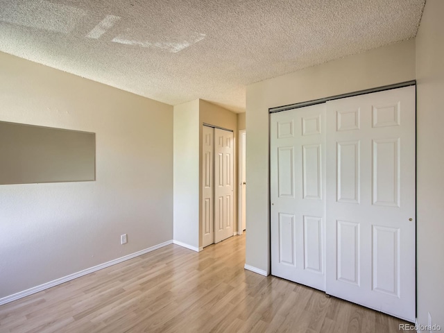 1200 Golden Cir Unit 412, Golden, CO 80401 - unfurnished bedroom featuring light wood-type flooring and a textured ceiling