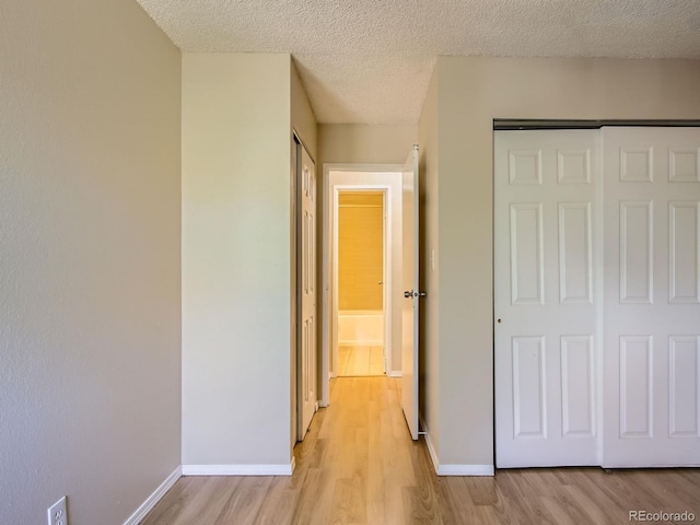 1200 Golden Cir Unit 412, Golden, CO 80401 - unfurnished bedroom with light wood-type flooring, a textured ceiling, and a closet