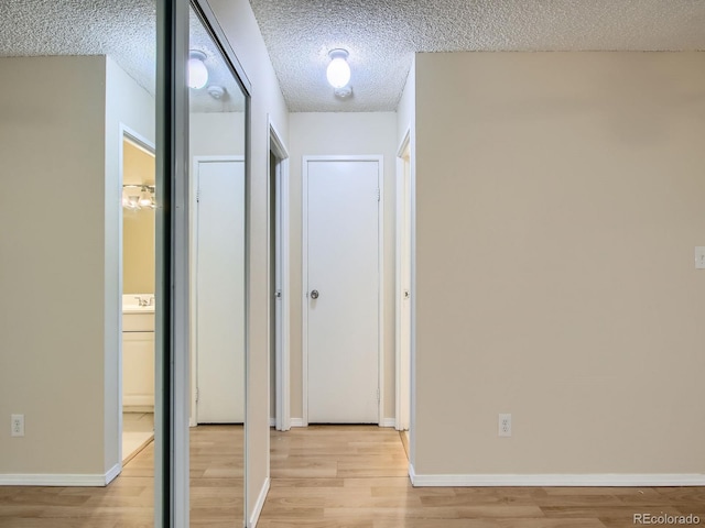 1200 Golden Cir Unit 412, Golden, CO 80401 - corridor featuring light wood finished floors and a textured ceiling