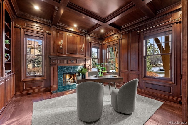 office area featuring dark wood-type flooring, wooden walls, ornamental molding, built in shelves, and wooden ceiling