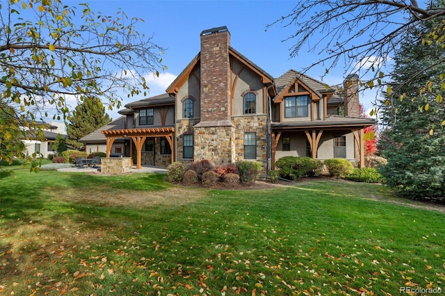 rear view of property with a yard and a patio