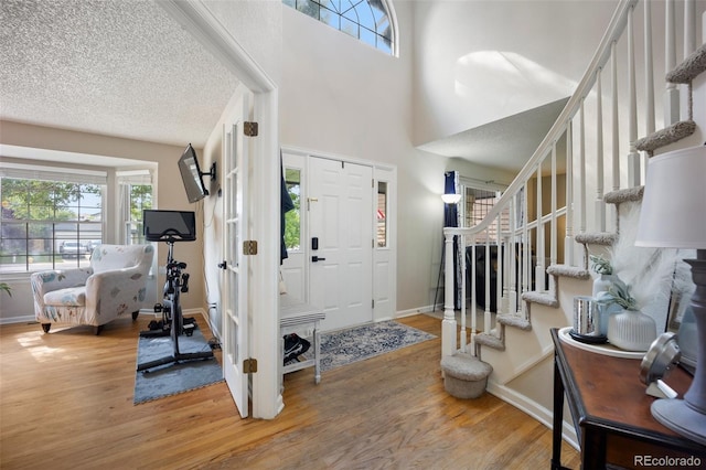 5552 S Lisbon Ln, Centennial, CO 80015 - foyer with light wood-style floors, stairs, and a high ceiling