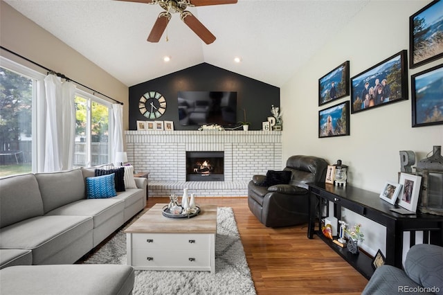 5552 S Lisbon Ln, Centennial, CO 80015 - living area with lofted ceiling, ceiling fan, wood finished floors, a brick fireplace, and recessed lighting