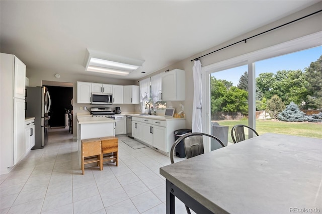 5552 S Lisbon Ln, Centennial, CO 80015 - kitchen featuring stainless steel appliances, light tile patterned floors, white cabinets, and light countertops