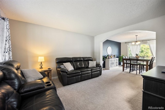 5552 S Lisbon Ln, Centennial, CO 80015 - living room with arched walkways, carpet flooring, and a textured ceiling