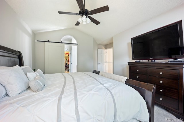 5552 S Lisbon Ln, Centennial, CO 80015 - bedroom with a barn door, lofted ceiling, light carpet, and a ceiling fan