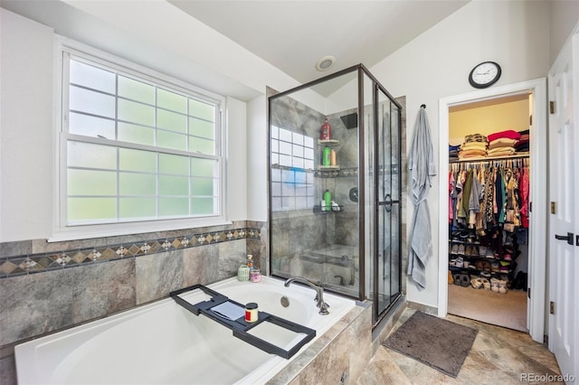 5552 S Lisbon Ln, Centennial, CO 80015 - full bathroom featuring a bath, a shower stall, and a walk in closet