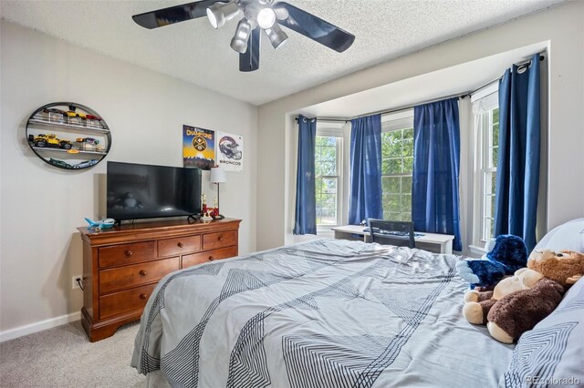 5552 S Lisbon Ln, Centennial, CO 80015 - bedroom with a textured ceiling, carpet, and ceiling fan