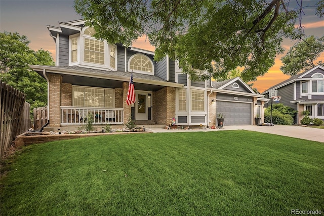 5552 S Lisbon Ln, Centennial, CO 80015 - view of front of property featuring covered porch, brick siding, concrete driveway, and an attached garage
