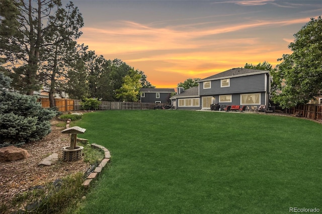 5552 S Lisbon Ln, Centennial, CO 80015 - yard at dusk with a fenced backyard and a patio
