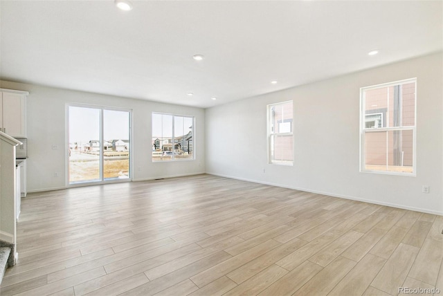 unfurnished living room with light hardwood / wood-style flooring