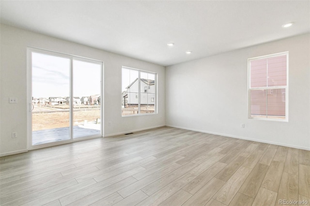 spare room featuring light hardwood / wood-style flooring