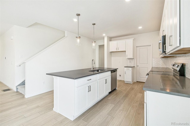 kitchen featuring sink, stainless steel appliances, light hardwood / wood-style flooring, a center island with sink, and white cabinets