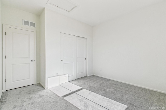 unfurnished bedroom featuring light colored carpet and a closet