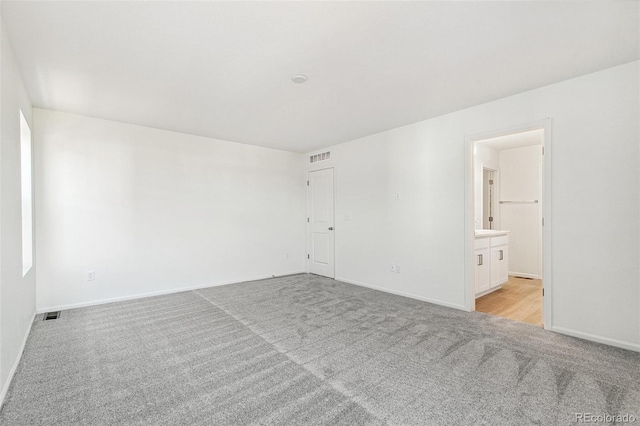 unfurnished room with light colored carpet