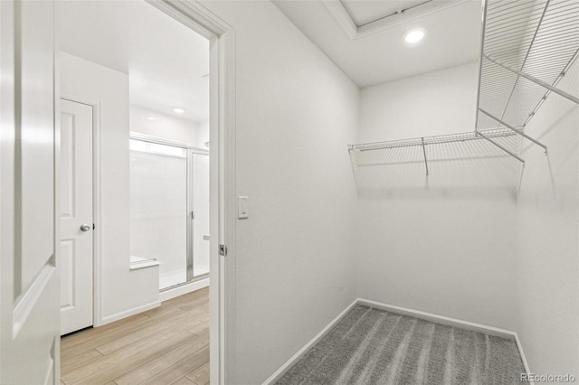 walk in closet featuring light hardwood / wood-style flooring