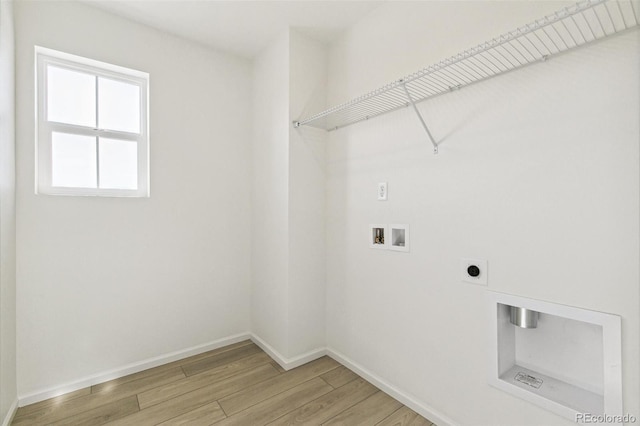 laundry room with hookup for an electric dryer, hardwood / wood-style floors, and washer hookup