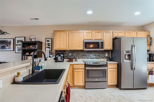 17390 Waterhouse Cir Unit B, Parker, CO 80134 - kitchen with stainless steel appliances, light brown cabinetry, light countertops, backsplash, and recessed lighting