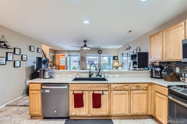 17390 Waterhouse Cir Unit B, Parker, CO 80134 - kitchen with appliances with stainless steel finishes, a peninsula, a ceiling fan, light brown cabinetry, and light countertops
