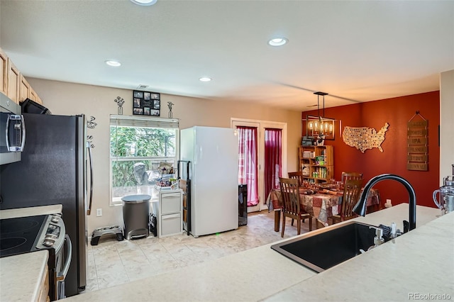 17390 Waterhouse Cir Unit B, Parker, CO 80134 - kitchen featuring stainless steel appliances, a chandelier, light countertops, recessed lighting, and hanging light fixtures