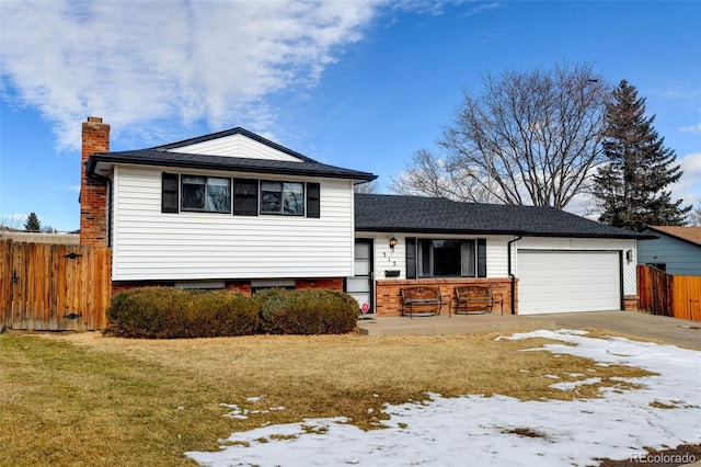 split level home with a yard and a garage