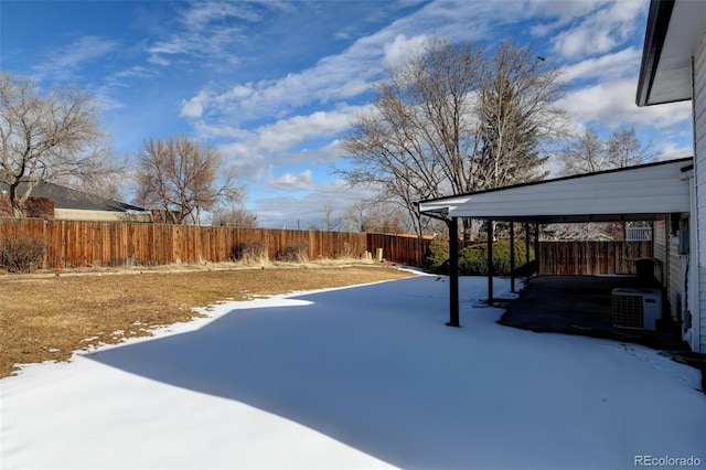 yard covered in snow with central air condition unit