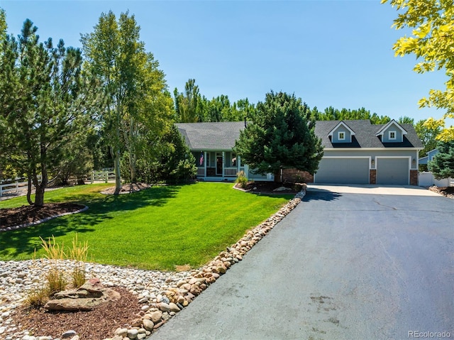 ranch-style house featuring a garage and a front lawn