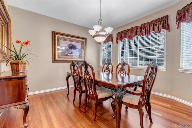 dining area featuring a notable chandelier and light hardwood / wood-style floors