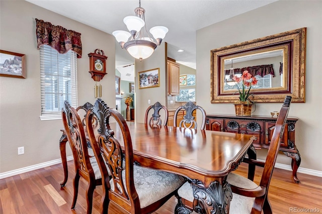 dining room with a chandelier and light hardwood / wood-style flooring