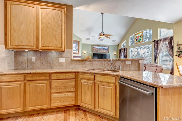 kitchen with sink, decorative backsplash, vaulted ceiling, stainless steel dishwasher, and kitchen peninsula