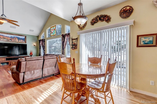 dining area featuring light hardwood / wood-style flooring, plenty of natural light, ceiling fan, and vaulted ceiling