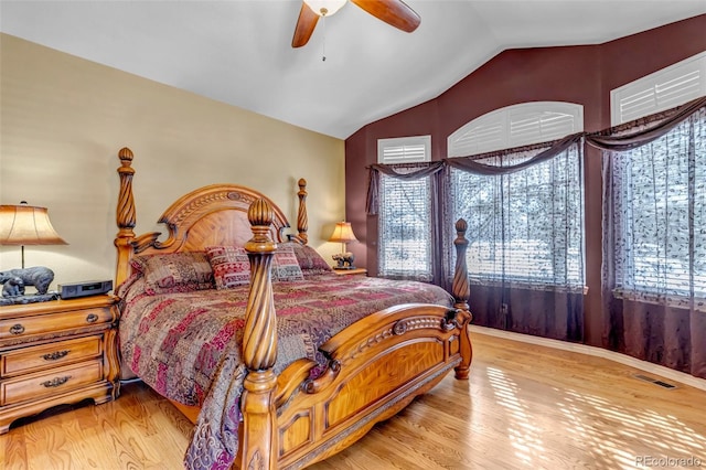 bedroom with vaulted ceiling, ceiling fan, and light hardwood / wood-style floors