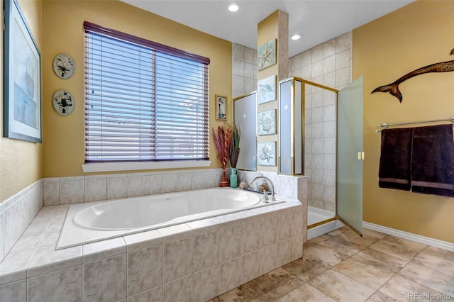 bathroom with separate shower and tub