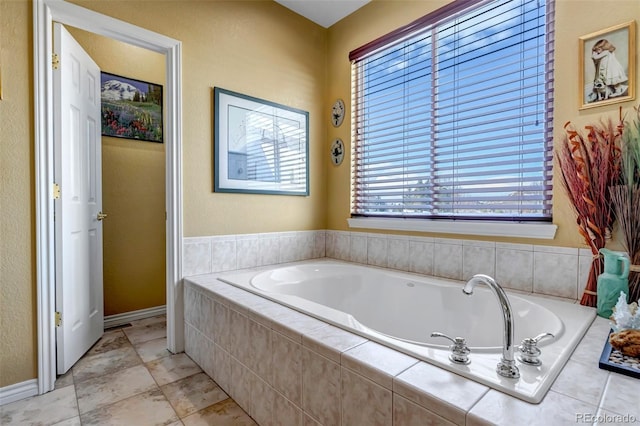 bathroom featuring tiled tub