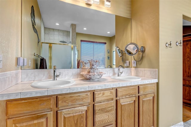 bathroom featuring vanity and a shower with shower door