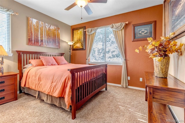 bedroom featuring light colored carpet and ceiling fan