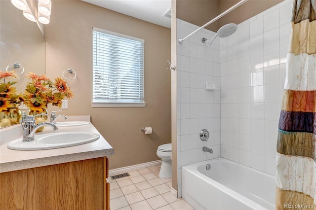 full bathroom featuring tile patterned flooring, vanity, shower / bath combo with shower curtain, and toilet