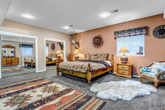 carpeted bedroom with two closets