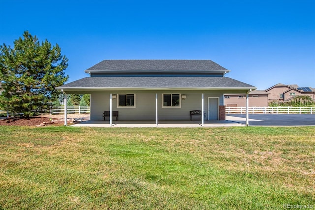 rear view of property with a yard and a patio area