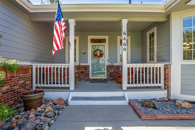 entrance to property featuring a porch