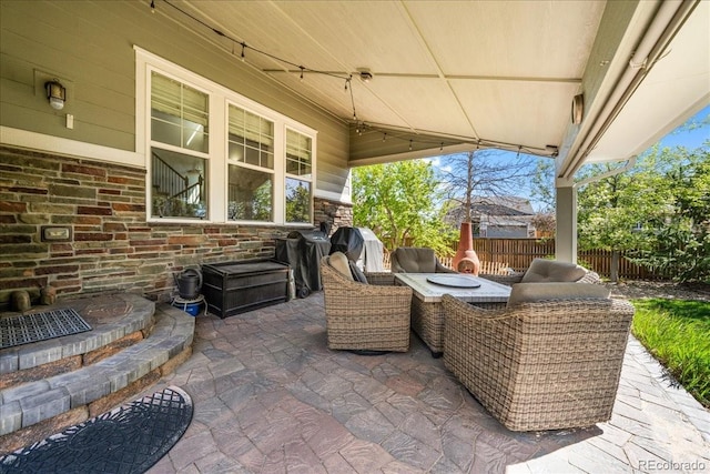 view of patio / terrace with fence and exterior kitchen