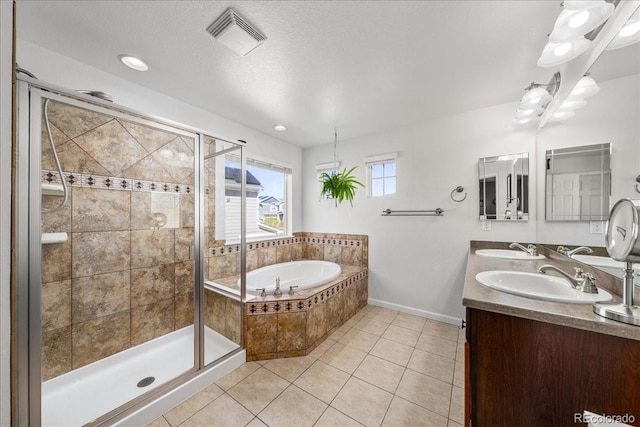 full bath featuring tile patterned floors, a garden tub, visible vents, and a sink
