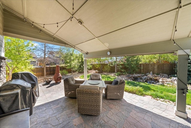 view of patio with outdoor dining area and a fenced backyard