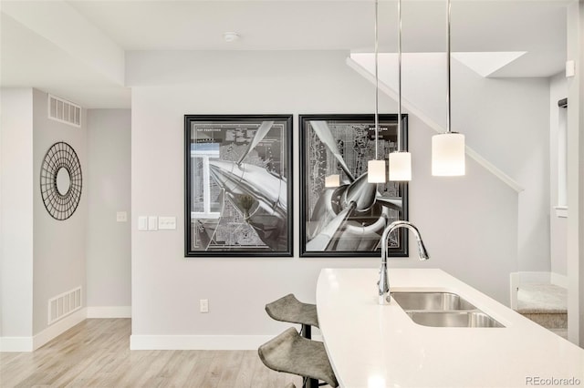 interior space featuring baseboards, visible vents, and wood finished floors